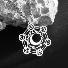 Unlock the divine energies of the universe with our captivating Archangel Metatron Cube Flower of Life Moon Necklace! 🌙✨ This exquisite piece of metaphysical jewelry combines the sacred symbols of the Metatron's Cube, the Flower of Life, and the phases of the moon, creating a powerful talisman for your spiritual journey. Crafted with utmost care and attention to detail, this necklace features a stunning pendant that showcases the intricate Metatron's Cube, a sacred geometric pattern that is bel Spiritual Moon Phase Pendant Jewelry, Spiritual Moon Phase Jewelry Gift, Healing Moon Phase Pendant Jewelry, Celestial Stainless Steel Jewelry With Moon Phase, Celestial Stainless Steel Jewelry For Gifts, Celestial Moon Jewelry For Meditation, Celestial Moon-shaped Jewelry For Meditation, Celestial Stainless Steel Moon Phase Jewelry, White Moon Phase Jewelry For Meditation