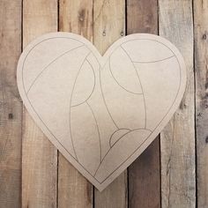 a heart shaped cutout sitting on top of a wooden floor