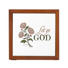 a wooden frame with flowers and the words let go to god in gold on it