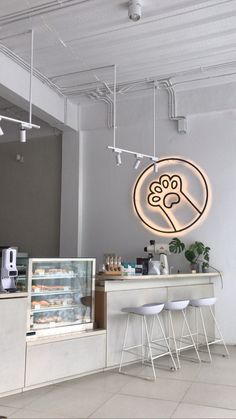 the interior of a bakery with white stools