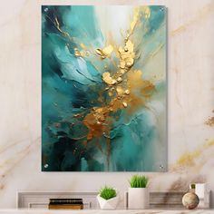 an abstract painting in gold and teal on a white wall above a fireplace mantel