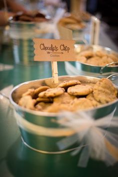 several tins filled with cookies on top of a table