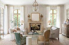 a living room filled with white furniture and lots of windows on top of each other