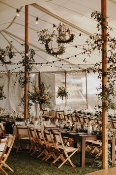 an outdoor wedding tent set up with tables and chairs