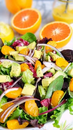 a salad with oranges, onions and avocado