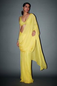 Yellow pre-draped saree. Paired with a crystal embellished blouse.
Components: 2
Pattern: Embellished
Type Of Work: Crystals
Neckline: Deep V Neck
Sleeve Type: Sleeveless
Fabric: Chiffon, Net
Color: Yellow
Other Details: 
Approx length: 44-46 inches
Occasion: Reception - Aza Fashions