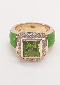 PERIDOT DIAMOND GREEN ENAMEL 14 KT GOLD RING-13.3GR SIZE=6.5 FINE DESIGN GLDRM STAMPED The item pictured is the exact item you will receive so view the photos carefully as they are part of the description A Authentic GLDRM Periodot & Diamonds Ring That Is Masterfully Crafted From Solid 14 Karat Yellow Gold and Green Enamel. This Beautiful Box Designed Ring Features Approximately 3.0 Carat Green Peridot Princess Cut  And 0.40 Carats Of Round Brilliant Cut Diamonds (24 stones) G-H Color And VS In Clarity.  This piece measures approximately 14.5mm x 14.5mm at the top of the ring and shank tapering to 5.5mm, and will fit a size 6-1/2 finger. There are Genuine Hallmarks as well as Purity Stamps present on this Ring. This piece weighs approximately 13.3 Grams NOTE: Very Small piece of enamel is Gold And Green, Diamonds Ring, Ring Pictures, Green Peridot, Green Enamel, Yellow Gold Ring, Round Brilliant Cut Diamond, Box Design, Princess Cut