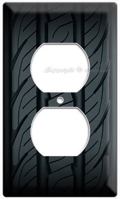 a black and white light switch cover with tire print on the front, and an outlet for