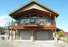 a two story house with an attached deck and balconies on the second floor