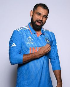 a man with a beard wearing a blue shirt