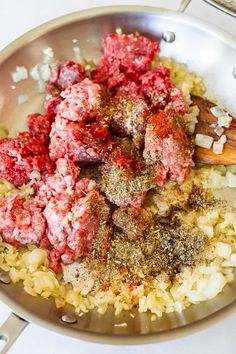 meatballs and onions are being cooked in a pan