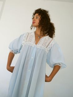 *Romantic vintage Christian Dior pale blue night robe with balloon sleeves and lace/eyelet/bow details.  Has pockets and button front closure. Fabric is a lightweight cotton gauze. *In excellent vintage condition. *Size not marked. Fits modern Small-Large. Shown on 5'5" frame. *Bust: 38" *Waist: 52" *Hip: 63" *Length: 56" *Fabric: Cotton. *Care: Hand wash in cool water; line dry. Vintage Light Blue Sleepwear With Lace Trim, 1800s Nightgown, Sleep Gown, Rich Fashion, Vintage Pajamas, Cotton Gowns, Linen Fashion, Vintage Nightgown, Blue Night