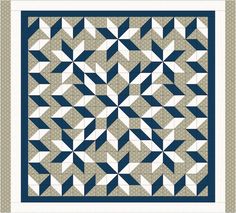 a blue and white quilt with an intricate design on the front, along with two rows of smaller triangles