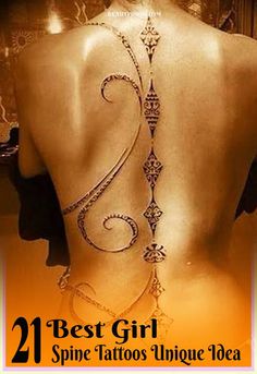 the back of a woman's body with an intricate tattoo on her lower back