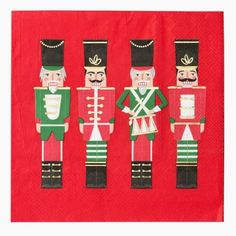 three nutcrackers on red paper napkins with gold trimming and green accents