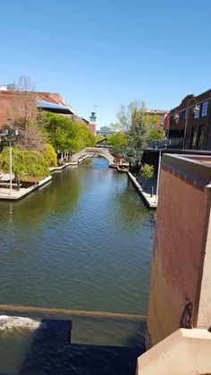 a river running through a city next to tall buildings