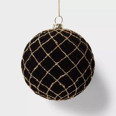 a black and gold ball ornament hanging from a chain