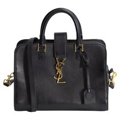 This bag is made of smooth calfskin leather in black. The bag features rolled leather top handles and a crossover strap with a weighted gold YSL monogram. The top zippers open to a matching black calfskin leather interior with zipper and patch pockets. Color: Black Material: Leather Style No: 322087 Measures: H 9” x L 10” x D 5” Drop: 3.75” (top handle) & 21” (shoulder strap) Condition: Good. Made in Italy Luxury Bags With Branded Hardware For Business Trips, Luxury Tote Satchel With Logo Hardware, Luxury Satchel With Logo Hardware, Modern Satchel With Logo Hardware For Formal Use, Modern Satchel With Logo Hardware For Formal Occasions, Modern Formal Satchel With Logo Hardware, Classic Travel Satchel With Logo Hardware, Luxury Shoulder Bag With Gold-tone Hardware For Business Trips, Luxury Rectangular Satchel With Logo Hardware