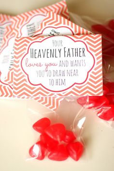 valentine's day candy bar wrappers with red candies in them on a table