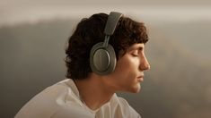 a young man wearing headphones looking off into the distance