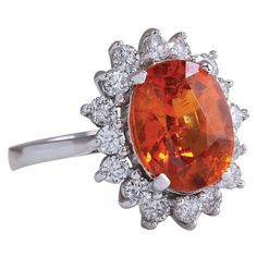 Stamped: 14K White GoldTotal Ring Weight: 4.8 GramsRing Length: N/ARing Width: N/AGemstone Weight: Total Natural Mandarin Garnet Weight is 5.01 Carat (Measures: 11.30x8.92 mm)Color: OrangeDiamond Weight: Total Natural Diamond Weight is 0.90 CaratColor: F-G, Clarity: VS2-SI1Face Measures: 17.70x15.18 mmSku: [702395W] Mandarin Garnet, Orange Diamond, 14k White Gold Diamond Ring, Garnet And Diamond Ring, Gold Diamond Ring, White Gold Diamond Rings, White Gold Diamonds, Color Orange, Natural Diamonds