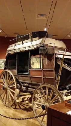 an old horse drawn carriage on display in a museum