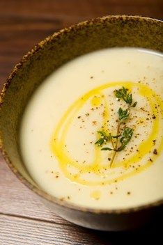 two bowls of cream of potato soup on a wooden table with the words perfect comfort