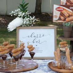 desserts are arranged on small trays in front of a sign