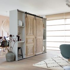 a living room filled with furniture and wooden doors