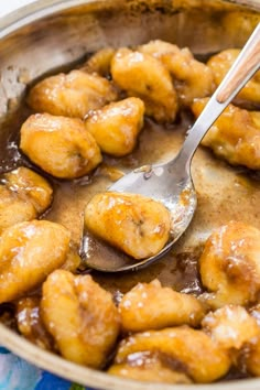 a close up of food in a pan with a spoon on the top of it