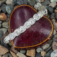 The bracelet features a total of three hundred seventy (370) channel set, mixed baguette cut diamonds and accented with an overlapping design. The bracelet measures 10.3mm wide, rises 6.6mm above the wrist by 7.25 inches long, finished with a hidden box clasp and fold-over safety. It fits up to a 6.75 inch wrist. Overlapping Design, Bracelet White Gold, Peridot Jewelry, Box Clasp, Baguette Cut Diamond, Channel Set, Baguette Cut, August Birth Stone, Baguette Diamond