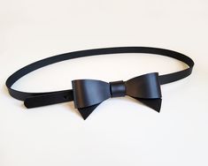 This beautiful and original belt is made of black firm natural leather. The leather bow on the front will perfectly accentuate your waist and highlight your personal style. The belt will look great on dresses and skirts. Belt closes with metal snap, which is hidden under leather bow- put belt tail through the loop and close it. The belt has three holes to adjust  your waist. ( In the video is a little bigger version of this belt) The size chart shows the waist circumference from the first hole t Chic Black Corset Belt For Formal Occasions, Chic Black Bow For Black Tie Events, Bow Belt, Leather Bow, Leather Bows, Suspender Belt, Waist Circumference, Black Colour, Suspenders