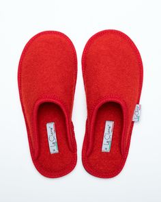 Description: The Le Clare women's Stella in red is the classic "hotel slipper" reimagined in luxurious boiled wool. This quintessential slipper provides delicate comfort and has been handcrafted, only for the most discerning, the Stella will not disappoint. Featuring our premium Italian boiled wool fiber, the slipper gently conforms to your foot for cozy comfort. The natural elasticity of our wool bounces back to its original shape, giving the slipper lasting appeal with a customized fit. This m Classic Indoor Slippers, Red Round Toe Slippers For Indoor Use, Red Slip-on Slippers With Rubber Sole, Red Comfortable Slip-on Slippers, Comfortable Red Slip-on Slippers, Wool Slip-on Indoor Slippers, Red Slip-on Slippers With Leather Sole, Comfortable Red Slippers With Rubber Sole, Red Leather Sole Slip-on Slippers