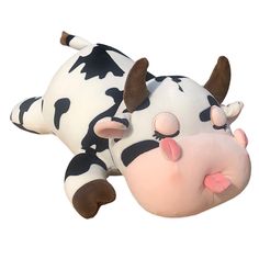 a toy cow laying down on its side