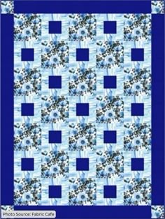 a blue and white quilt with flowers on it