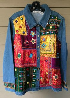 a denim jacket with multicolored patches on it