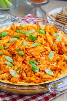 a casserole dish with chicken and green onions