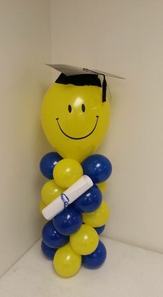 a balloon sculpture with a graduation cap on top