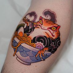 a close up of a person's arm with a tattoo on it that has an image of a cat eating noodles