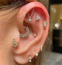 a close up of a person with ear piercings on their ears and behind the ear