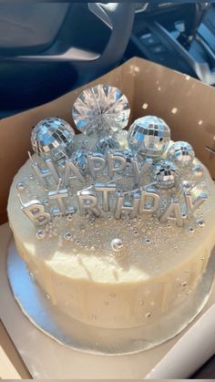 a birthday cake with frosting and decorations in a box