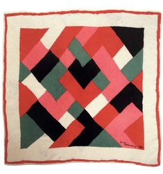 a red, black and white quilt with an abstract design on the bottom half of it