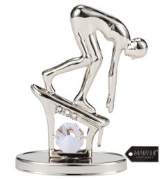 a silver figurine with a white diamond on it's face and legs