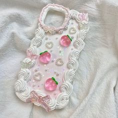 an iphone case made out of plastic and decorated with pink roses, pearls and swaroons