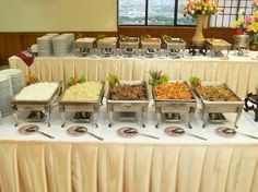 a buffet table filled with lots of food