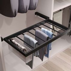 an open drawer with towels hanging from it