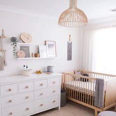 a baby's room with a crib and dresser