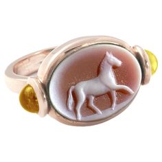 One-of-a-kind Rossella Ugolini Design Collection a perfectly hand carved Carnelian ring Handcrafted in yellow gold embellish with two yellow Citrine cabochon cut . The carved horse is rare and unique hand carved stone. only one Carnelian Horse in stock. available any size on order. Unisex Unique Design Signet Ring for a Horse Lovers. The horse is a solar animal. Due to its powerful musculature and its fiery character, it symbolizes the strength of instinctive energy. It is the mount of divine me Hand Carved Stone, Modern Deco, Carnelian Ring, Cameo Ring, Carved Stone, White Horses, Horse Lovers, Honey Colour, Yellow Citrine