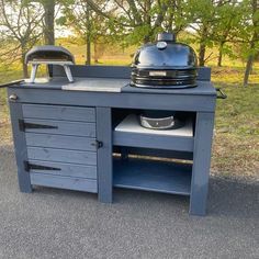 an outdoor grill on the side of a road