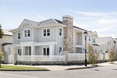 a large white house on the corner of a street